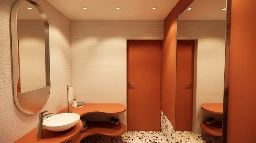Toilette con mesada curva, espejo oval y piso de terrazo